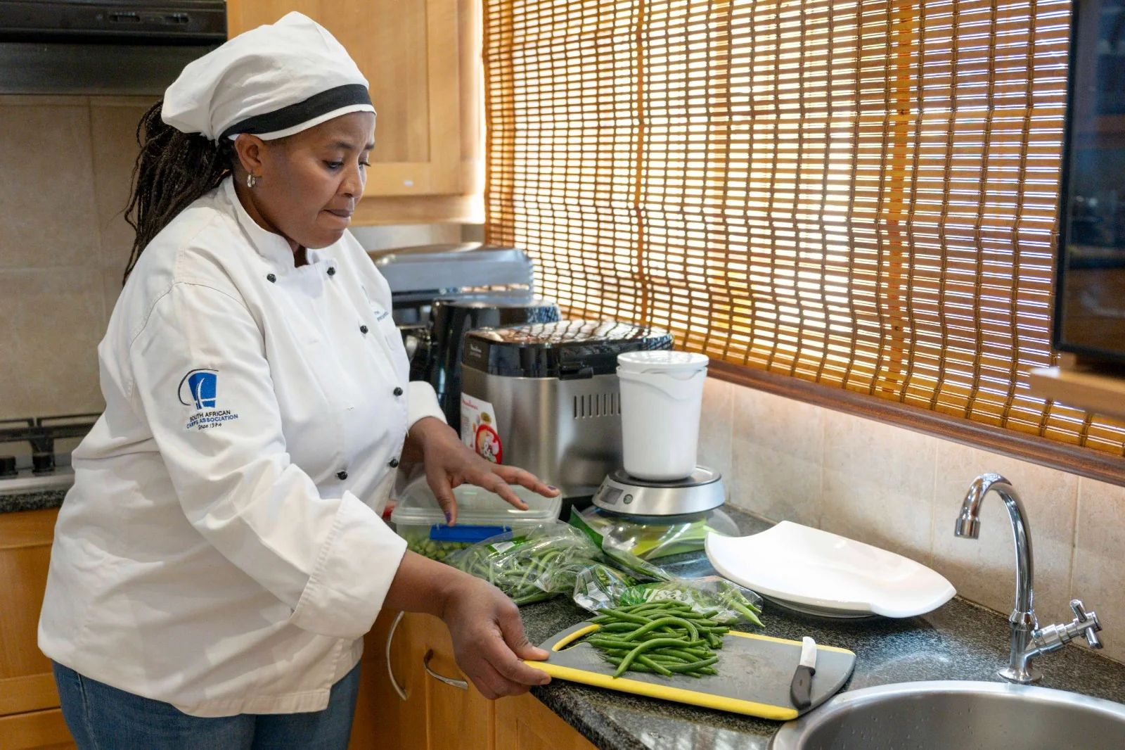 Joyce preparing fresh green beans in the kitchen
